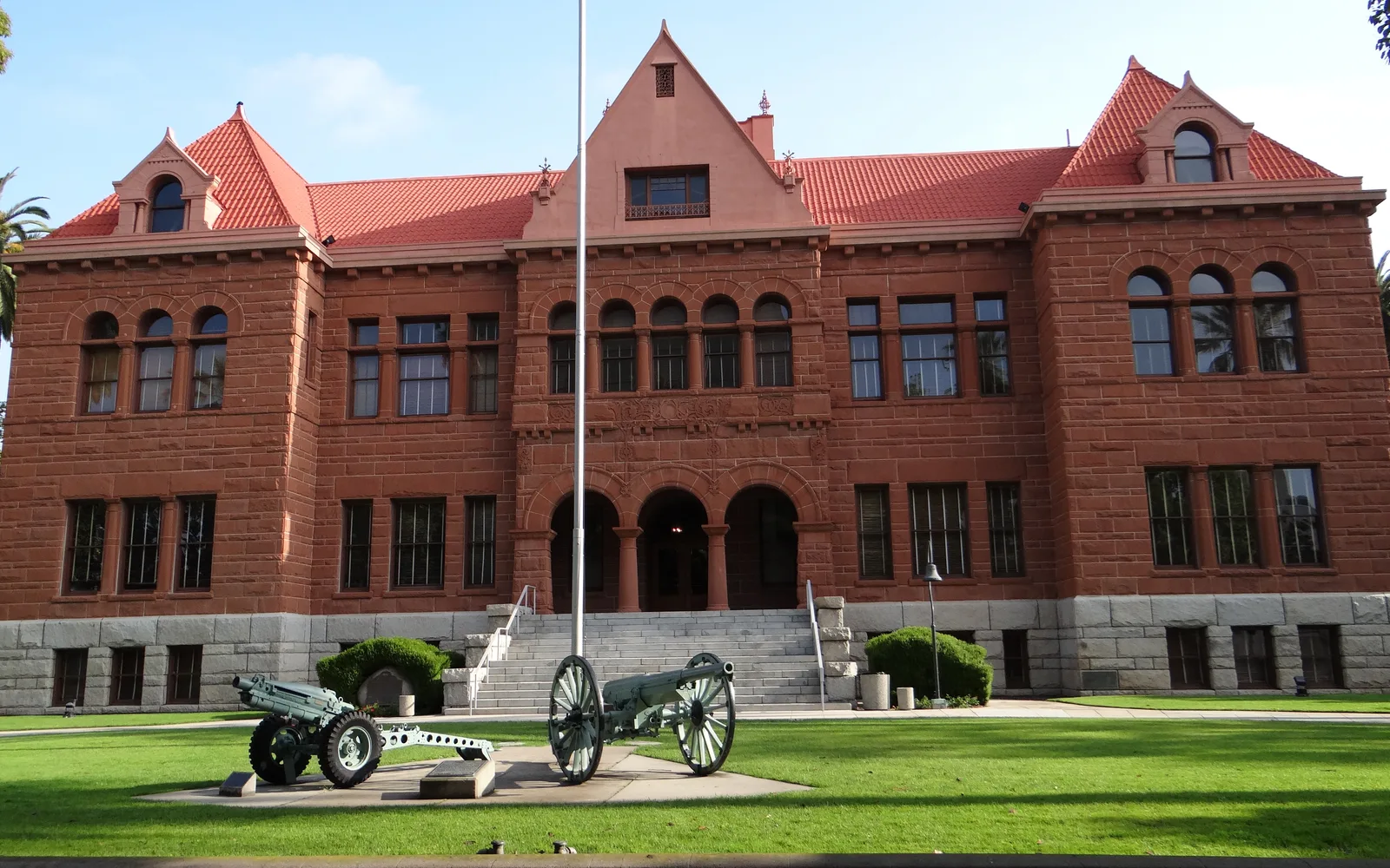 The Old Orange County Courthouse, a Romanesque Revival building in Santa Ana, California, with its distinctive brick and stone facade and tower.